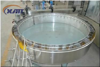 Rotary bottle feeding table with frequency changer and adjustable speed